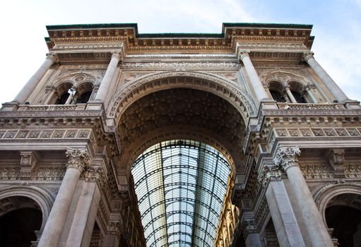 The Galleria Vittorio Emanuele II is a covered double arcade formed of two glass-vaulted arcades at right angles intersecting in an octagon, prominently sited on the northern side of the Piazza del Duomo in Milan.