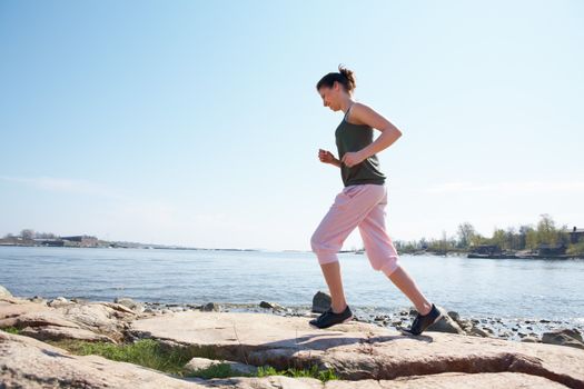 Teenage girl jogging by sea