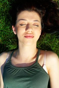 Teenage girl relaxing in grass, elevated view