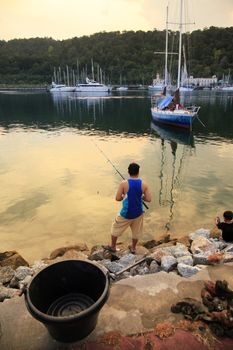 Fisherman at sunset. Island Langkavi, Malaysia