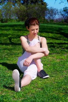 Teenage girl stretching in park