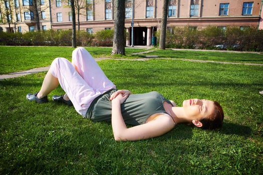 Teenage girl  resting in park in spring