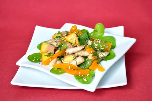 salad vegetables and fruit with chicken and arugula