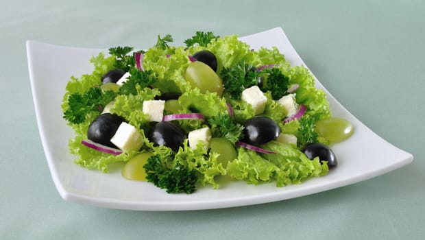 Salad of lettuce with cheese and grapes of different varieties