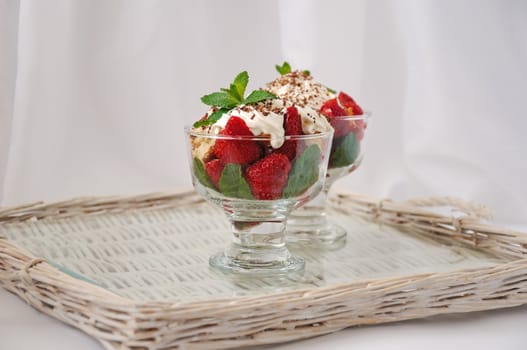 Strawberries with biscuit pieces with mint whipped cream with a grated chocolate