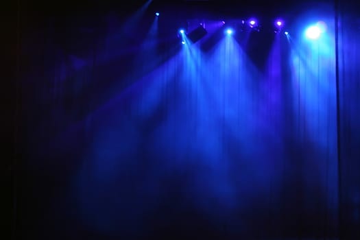 Blue stage light behind curtain