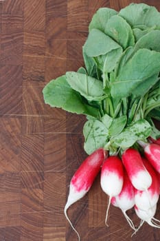 A bunch of radishes on a wooden backgroung