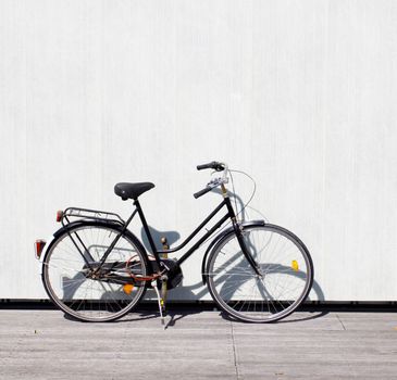 A bike leaning on a wall