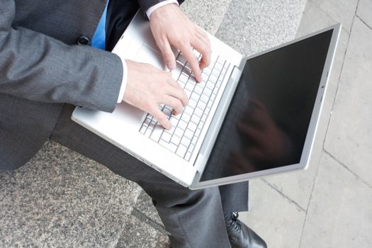 Business man sitting on stairs outdoor