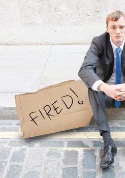 A worried business man sitting on the street