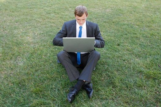 Business man sitting in the park