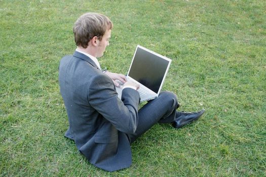 Business man sitting in the park