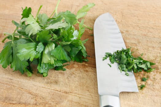 Chopping parsley on a wooden surface