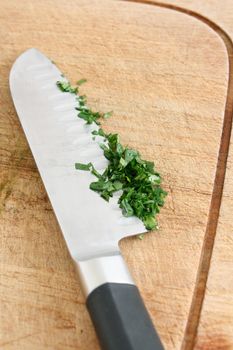 Chopping parsley on a wooden surface