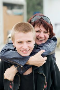 The happy mother and a son hugging and laughing