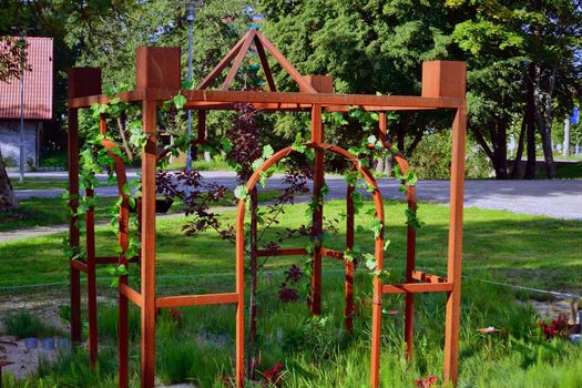 green garden with wrought iron arbor