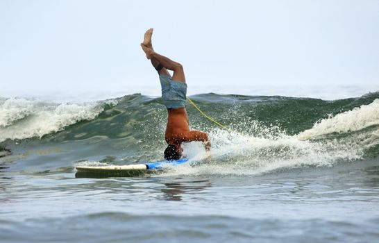 Young men - the surfer in ocean. Bali. Indonesia