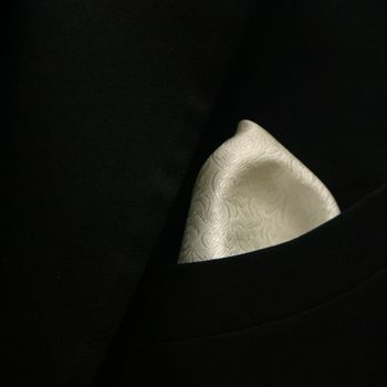 a close up image of grooms tuxedo