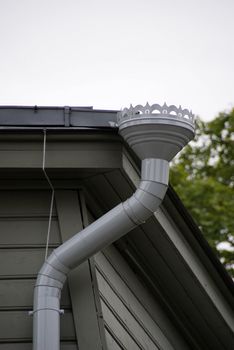 The modern drainpipe is established on the wooden house