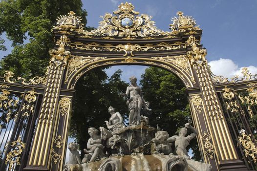 fountain framed by a golden gate in Stanislas square Nancy, France