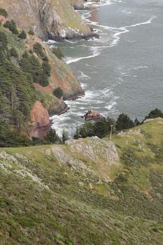 Landscape with hills by the ocean on overcast day