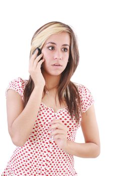 Portrait of shocked woman talking on phone call over white background