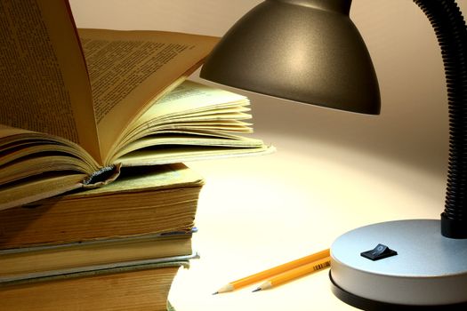 A lamp and books on the table