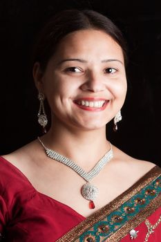Smiling Indian happy woman wearing  beautifully embroidered sari