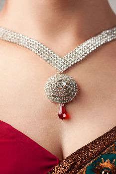 Close up of diamond necklace over female body skin