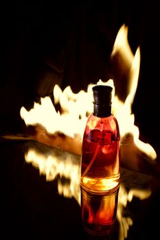 bottle of perfume on the fire background