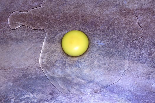 an egg and yolk on the brown tile