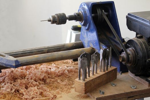 blue wood carving machine with chisel keys and shavings 