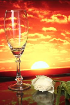 a goblet and the flower on the sunset background