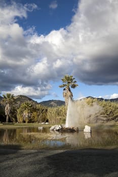 A natural geyser shooting water out of the ground and into the air