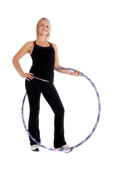 Fit blond woman holding a hula hoop, fitness theme.