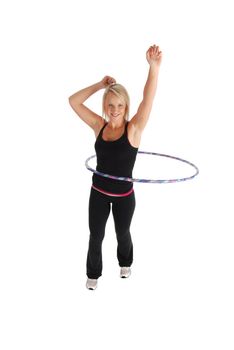 A blond woman exercising using a hula hoop
