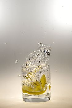 a glass of water and a lemon