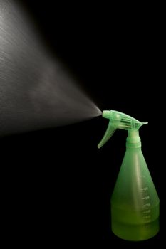 a green pulverizer on the black background