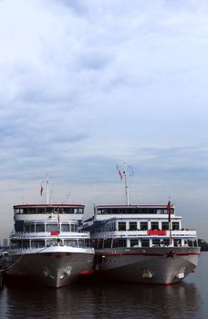 two ships on the water, sky and a river 