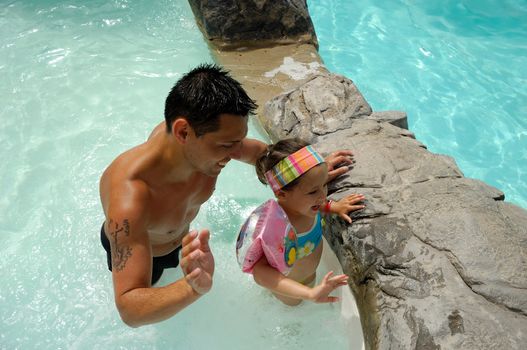 Father and daughter happy in pool