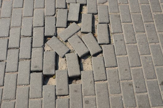 Small tiled sidewalk. Few stolen ones. Background.