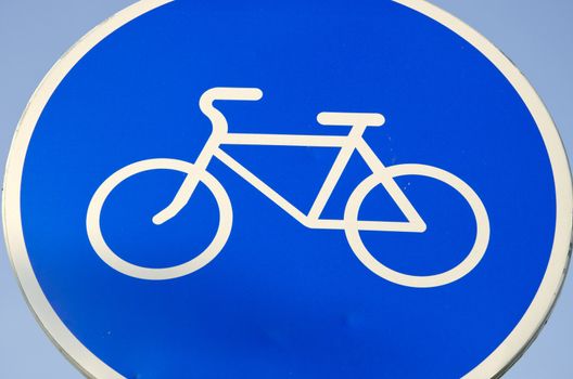 White bicycle sign in blue background. Road sign bicycle path.