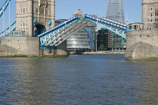 Tower Bridge in open position to allow passage of ships and boats. Historic bridge across the River Thames in London, England