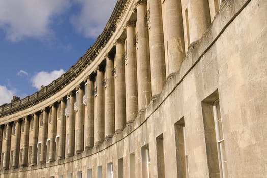 Royal Crescent in Bath, Somerset, England. Historic Georgian style building made of honey colored sandstone.