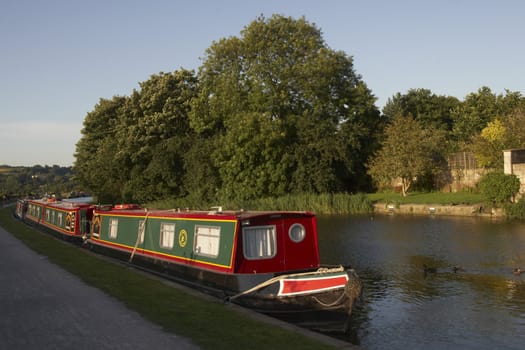 Canal boats tied up on the bank of the Kennet and Avon Canal at Bath, Somerset, England