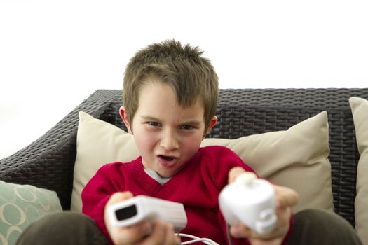 6 Years old kid playing computer games.