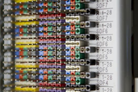 Telecommunications wire panel, mostly empty wire pins shows telecom industries standard colors in horizontal.