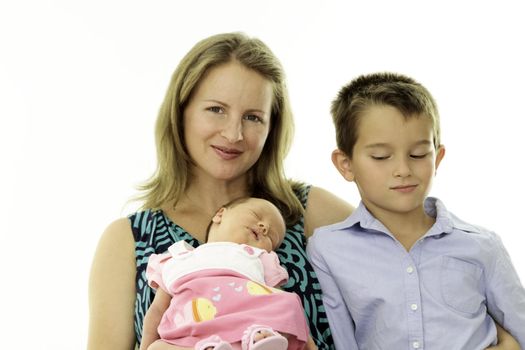 Mother holding her newborn baby while her brother looking at her sister jealously.