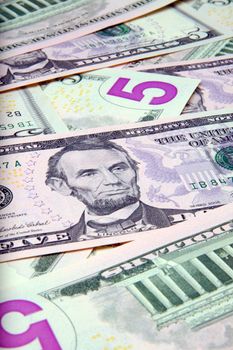 Pile of US $5 bills - new fives