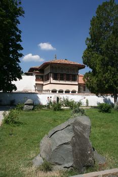 The historical house, the dark blue sky, the big stone
